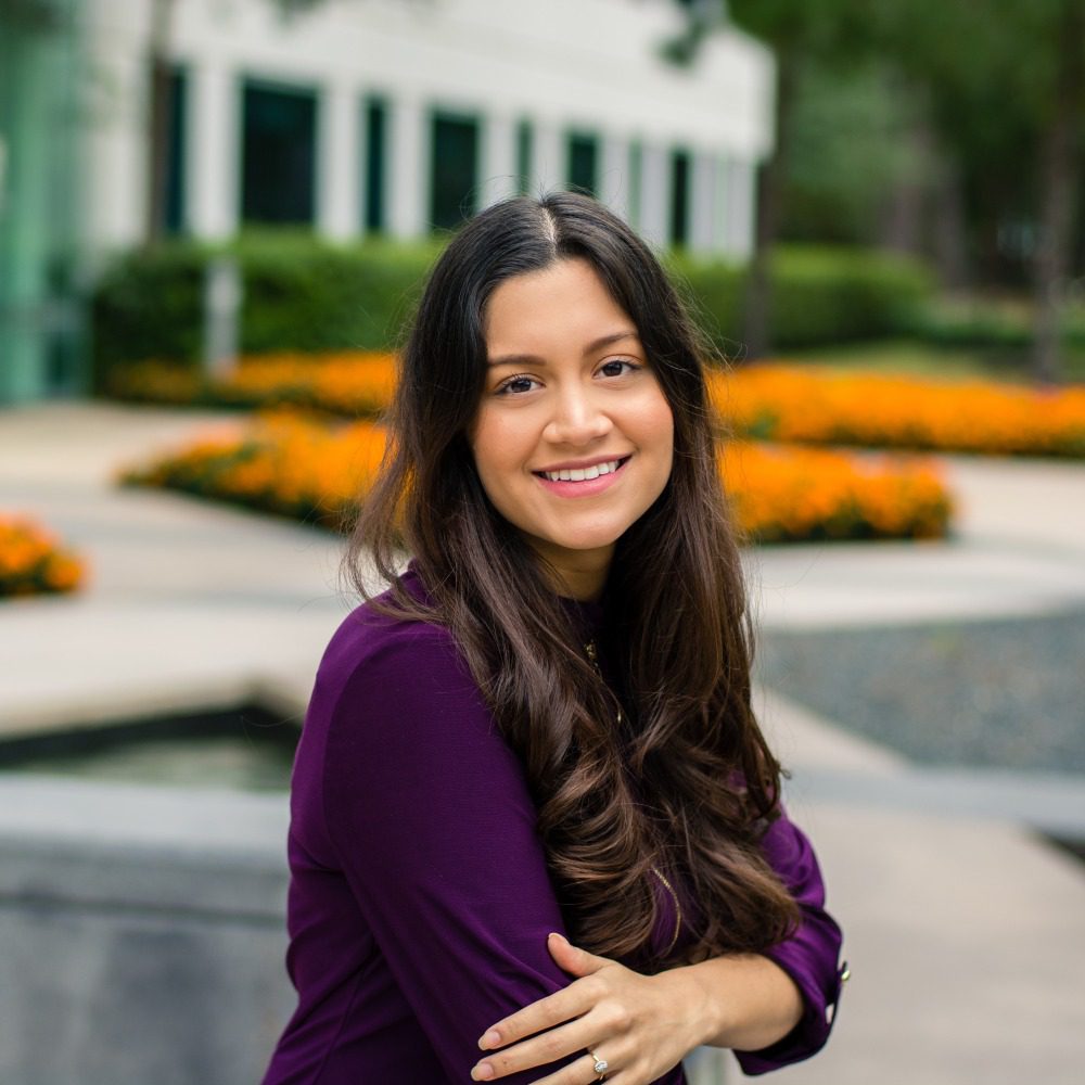 Woman in purple sweater near garden