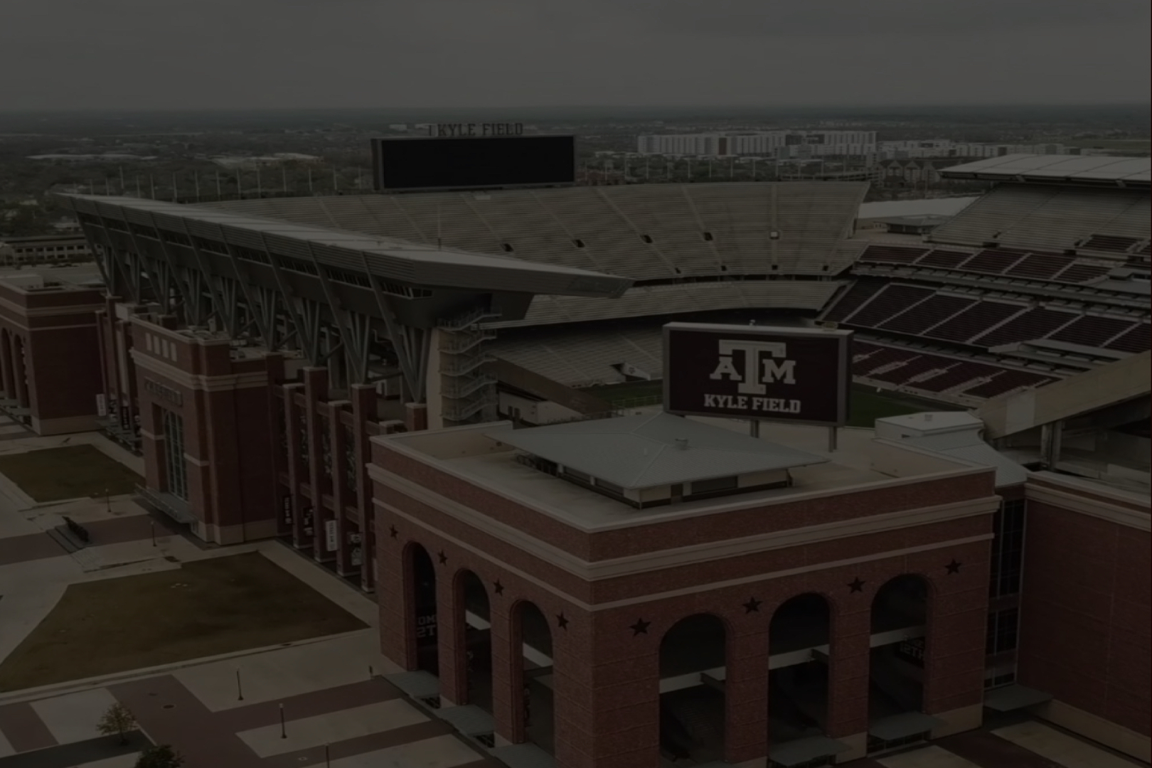A large stadium with Texas A&M branding under a cloudy sky.
